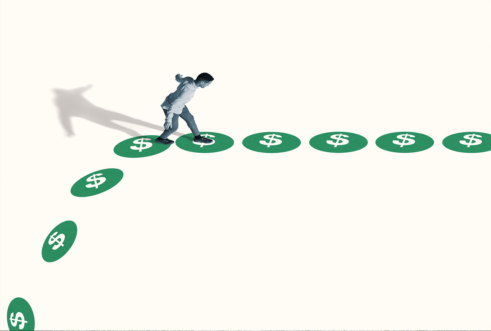 High angle side view of watchful young man walking on green dollar signs against white background (Getty Images)