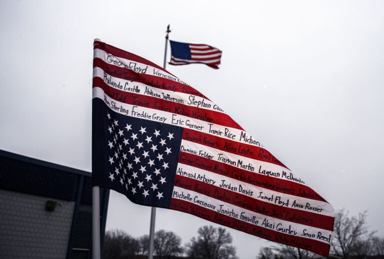 An upside-down American flag bearing the names of people killed by police is displayed during a protest on April 13, 2021 in Brooklyn Center, Minnesota. (Stephen Maturen/Getty Images)
