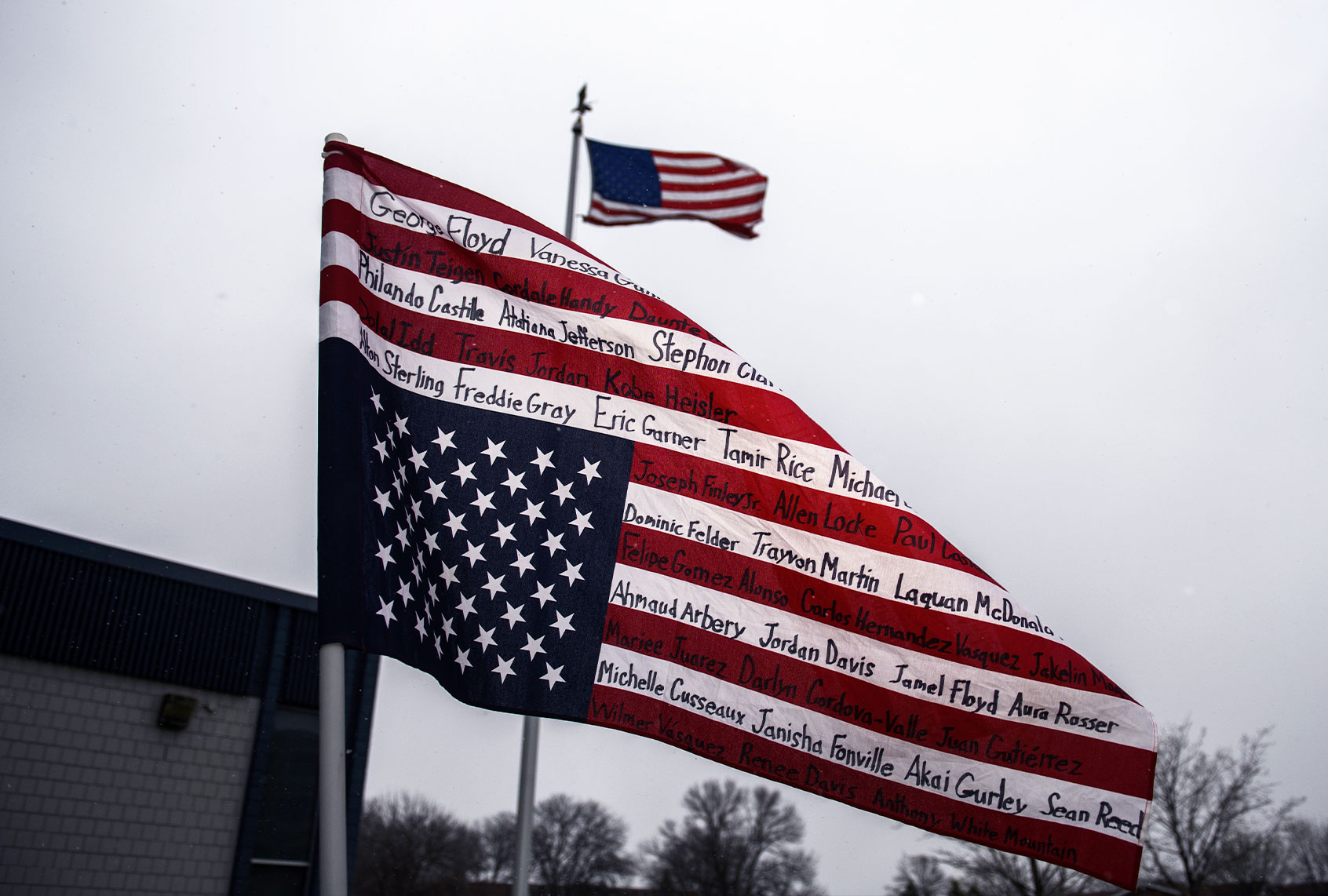 An upside-down American flag bearing the names of people killed by police is displayed during a protest on April 13, 2021 in Brooklyn Center, Minnesota. (Stephen Maturen/Getty Images)