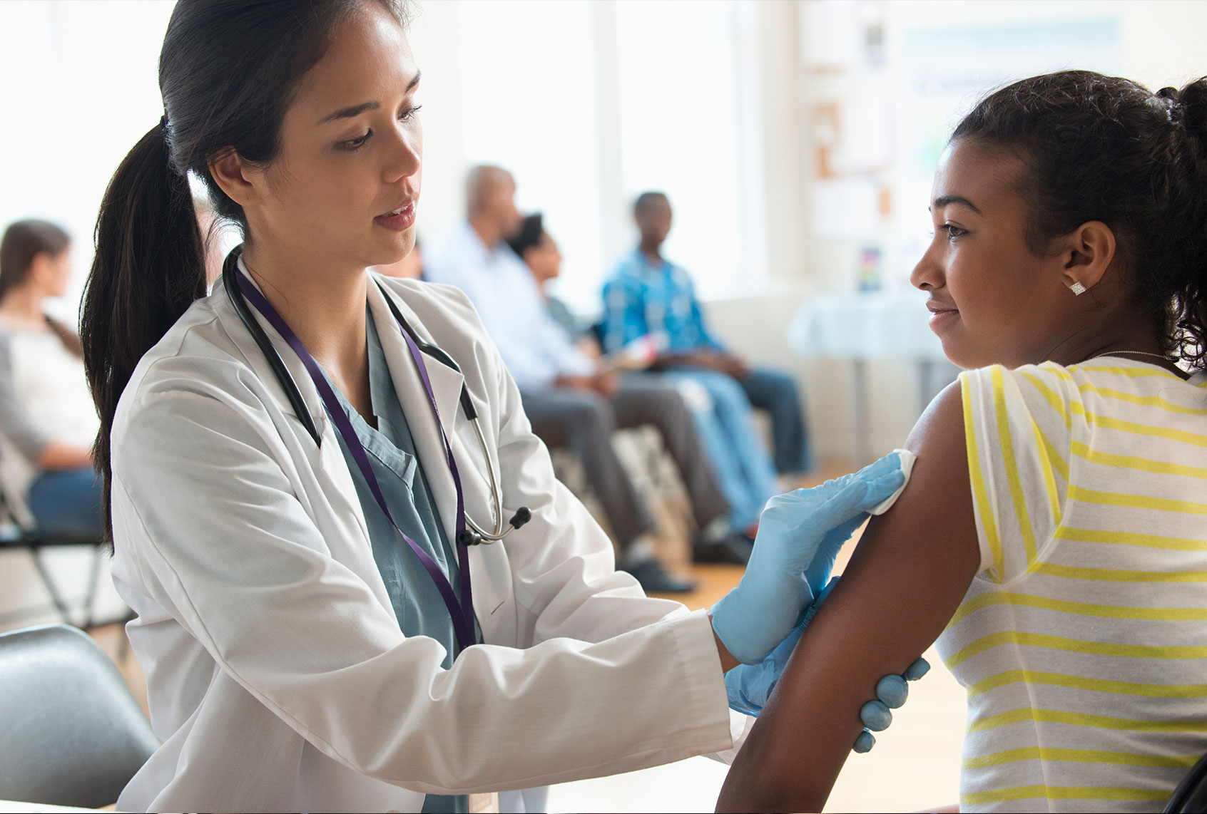 Doctor disinfecting arm of patient in volunteer clinic (Getty Images)