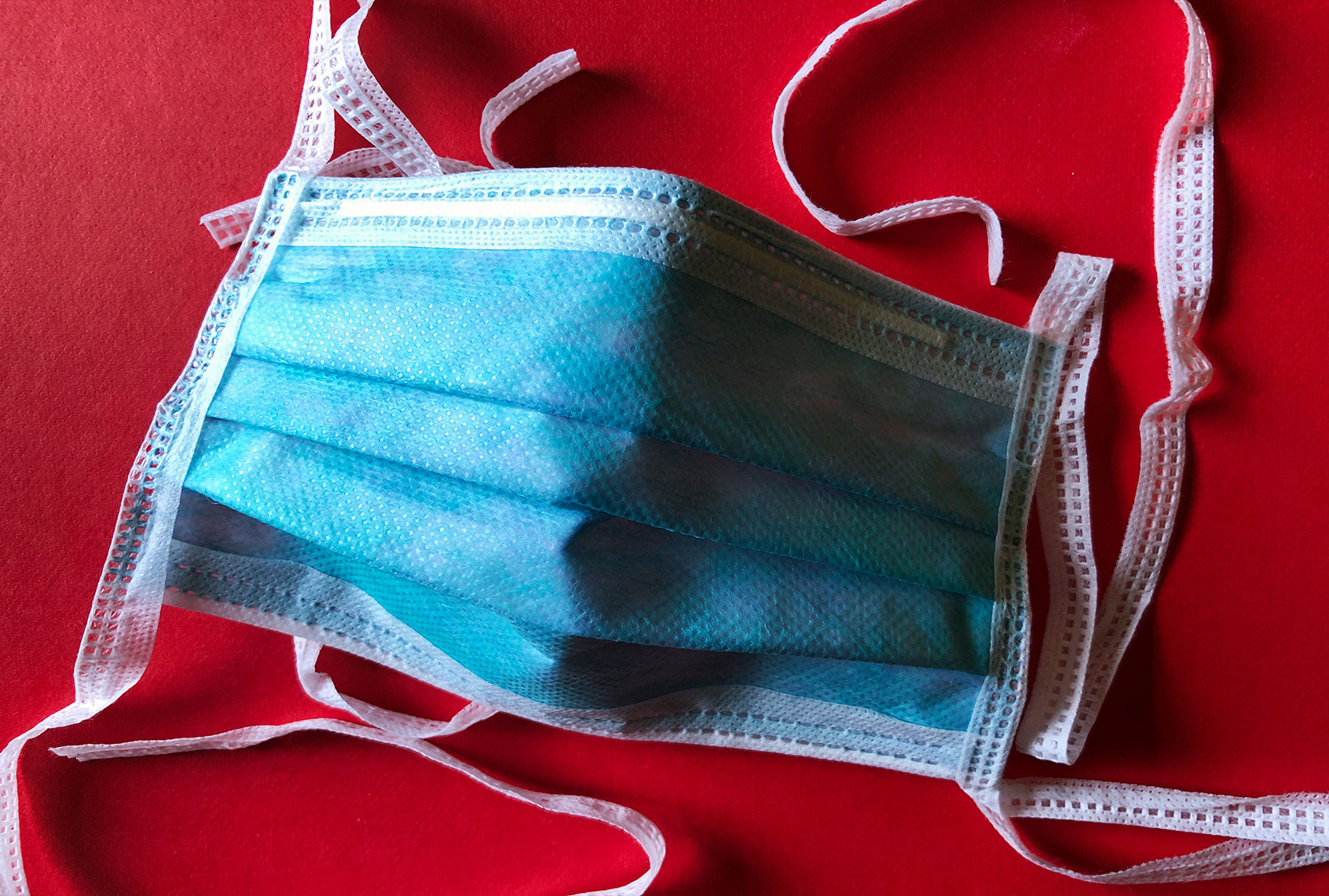 Medical Mask On Red Background (Getty Images)