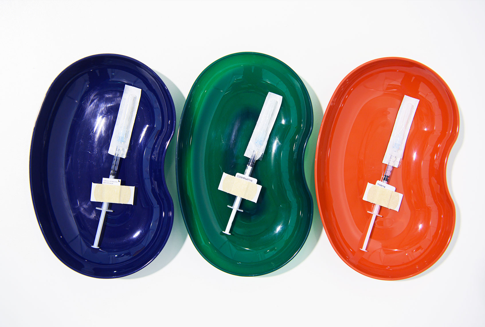 Syringes with the Astrazeneca active ingredient (l-r), Comirnaty from Biontech/Pfizer and from Moderna lie prepared in trays for vaccination against Corona. (Robert Michael/picture alliance via Getty Images)
