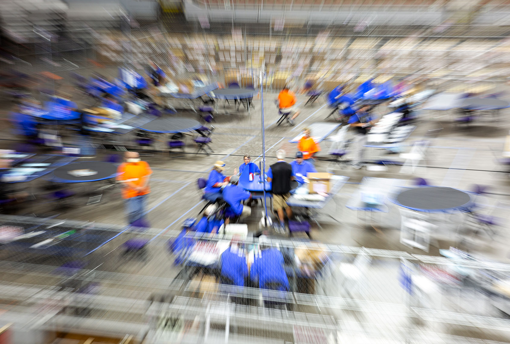 Contractors working for Cyber Ninjas, who was hired by the Arizona State Senate, examine and recount ballots from the 2020 general election at Veterans Memorial Coliseum on May 1, 2021 in Phoenix, Arizona. The Maricopa County ballot recount comes after two election audits found no evidence of widespread fraud. (Courtney Pedroza/Getty Images)
