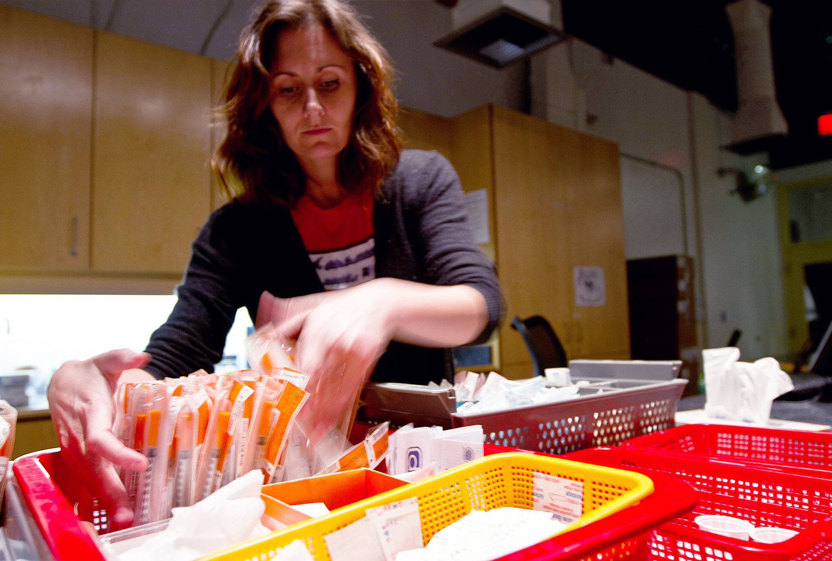 A worker at the Insite supervised injection Center in Vancouver, Canada, arranges syringes to be used by addicts on May 3, 2011 (Laurent Vu The/AFP via Getty Images)