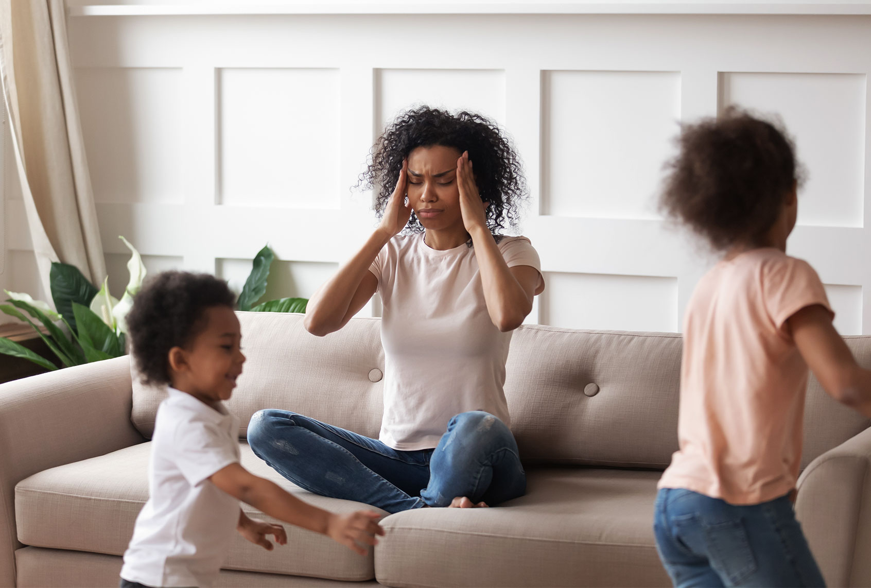 Mother suffers from headache because of noise of little children (Getty Images)