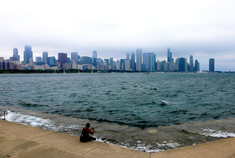 The waters of Lake Michigan crashes over the pedestrian walk as fog rolls through the Chicago skyline in Chicago, Illinois. (Raymond Boyd/Getty Images)