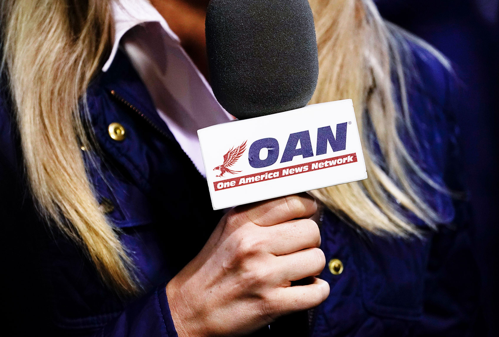 A reporter with One America News Network microphone (Drew Angerer/Getty Images)
