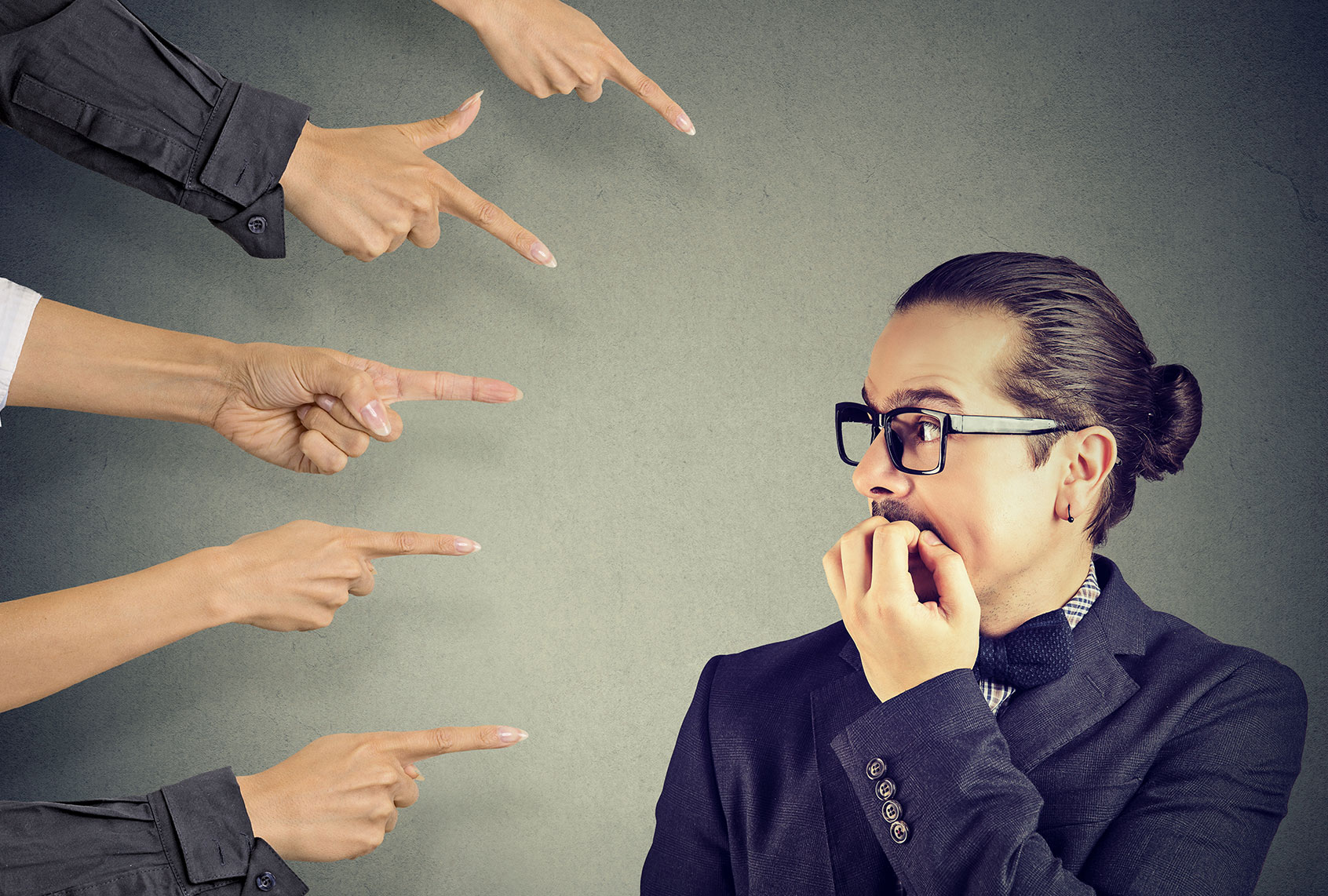 Anxious man scared of being judged by different people (Getty Images/SI Photography)