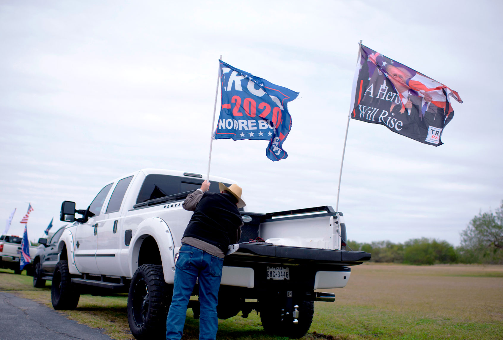 A supporter of US President Donald Trump decorates his truck before a Trump Train rally in Harlingen, Texas (MARK FELIX/AFP via Getty Images)
