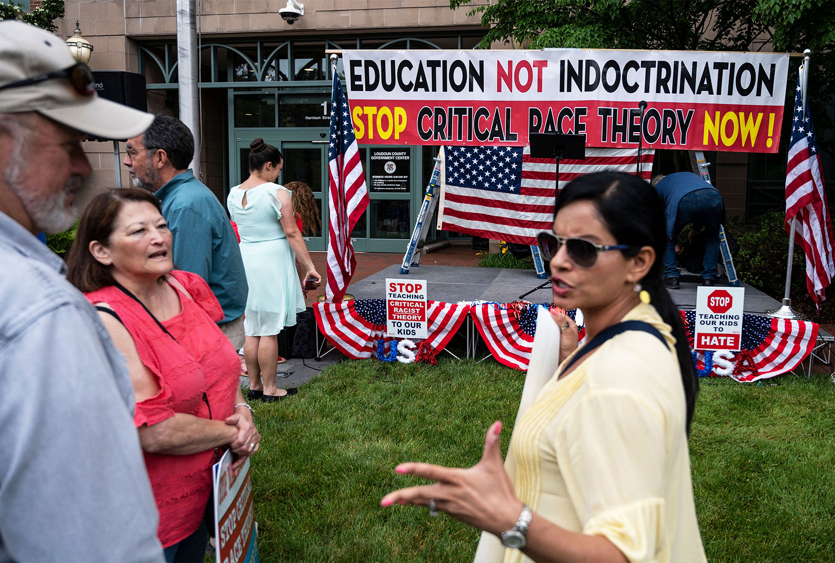 People hold up signs during a rally against "critical race theory" (CRT) being taught in schools at the Loudoun County Government center in Leesburg, Virginia on June 12, 2021. (ANDREW CABALLERO-REYNOLDS/AFP via Getty Images)