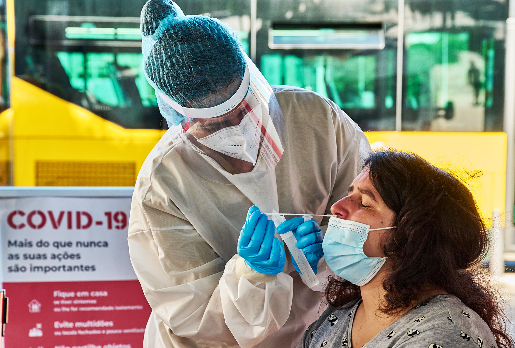 Health technician clad in full protective equipment performs a nasal swab for the antigen COVID-19 test (Horacio Villalobos/Getty Images)