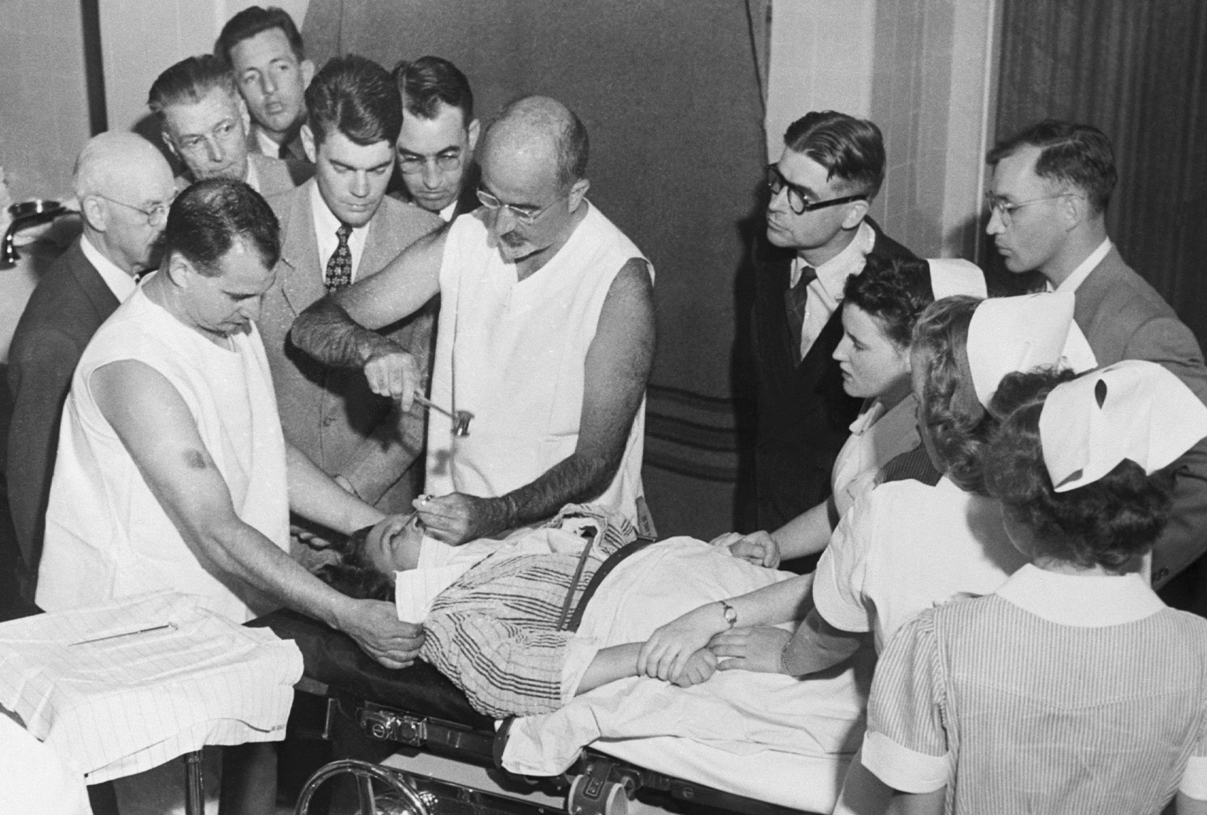 Dr. Walter Freeman performs a lobotomy using an instrument like an ice pick which he invented for the procedure. Inserting the instrument under the upper eyelid of the patient, Dr. Freeman cuts nerve connections in the front part of the brain. (Getty Images/Bettmann Contributor)