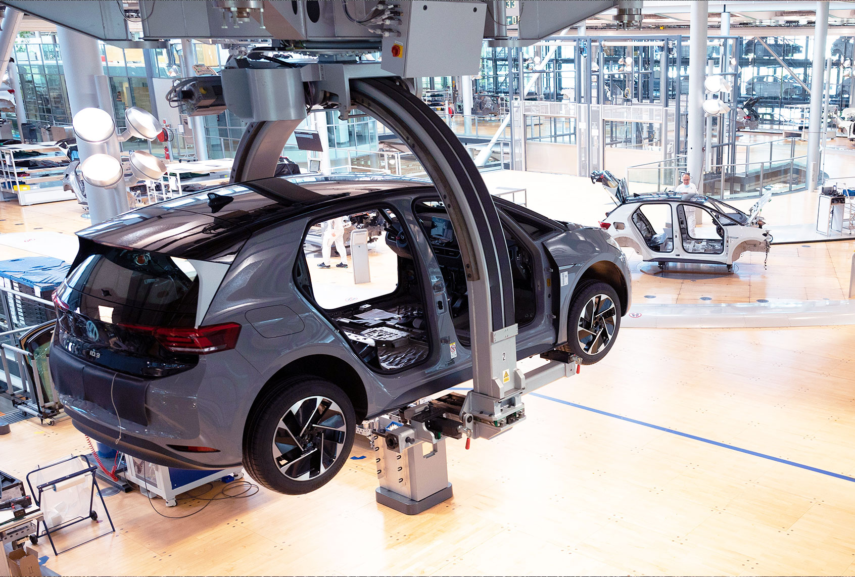 The body of a VW ID.3 hangs on a production line during a press tour of Volkswagen's Transparent Factory. At the site in Dresden, 35 fully electric vehicles are produced every day. (Effect due to long exposure) (Sebastian Kahnert/picture alliance via Getty Images)