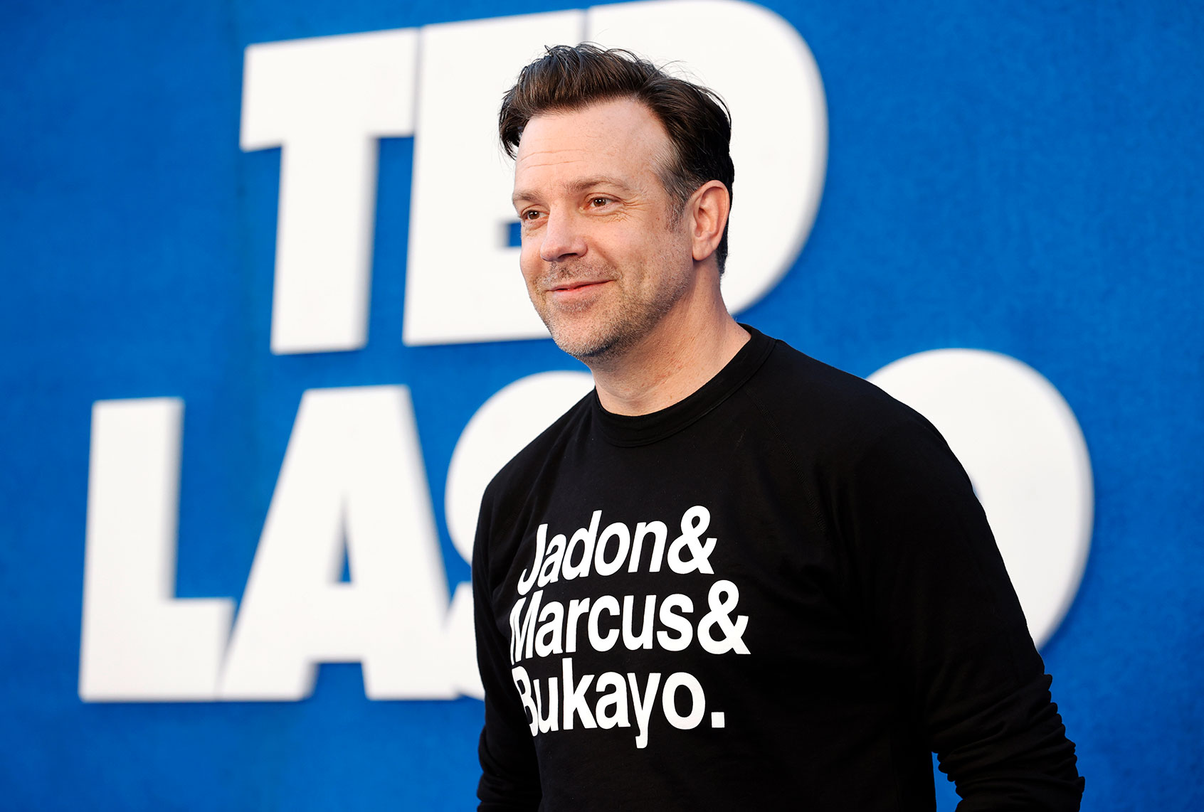 Jason Sudeikis wears a top featuring the names of England football players Jadon Sancho, Marcus Rashford and Bukayo Saka as he attends Apple's "Ted Lasso" Season 2 Premiere at Pacific Design Center on July 15, 2021 in West Hollywood, California. (Frazer Harrison/FilmMagic)
