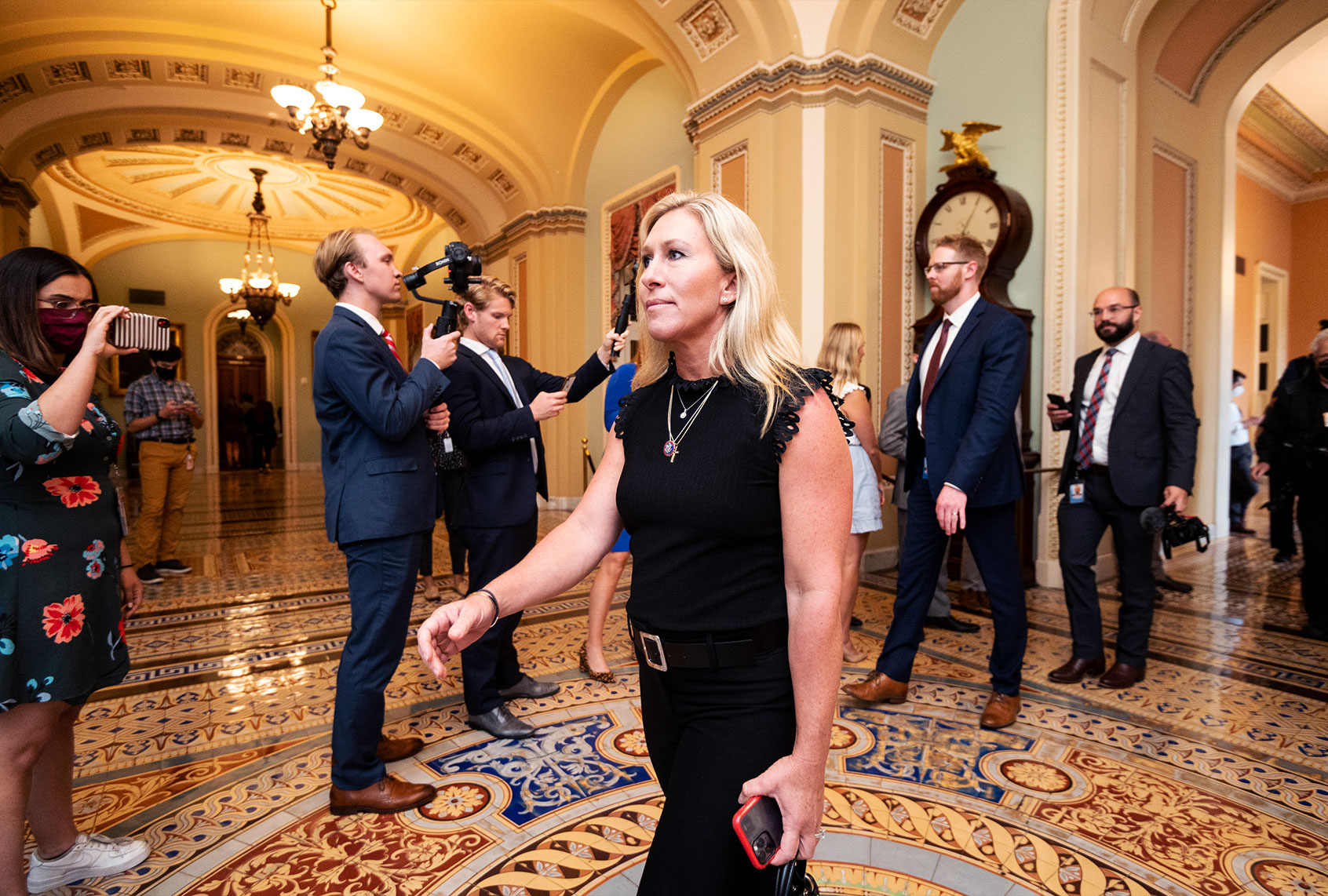 Rep. Marjorie Taylor Greene, R-Ga., walks through the Ohio Clock Corridor to the Senate chamber as a group of maskless Republican members of Congress made their way to the Senate in the Capitol on Thursday, July 29, 2021. The members were drawing attention to different mask rules on the House and Senate sides of the Capitol. (Bill Clark/CQ-Roll Call, Inc via Getty Images)