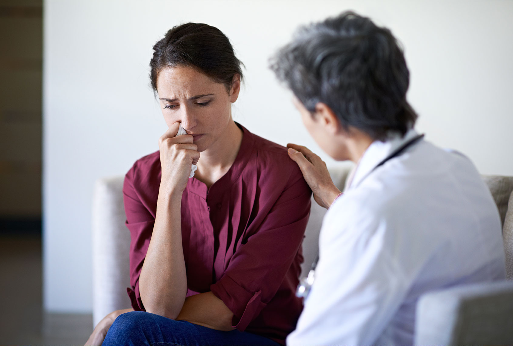 Doctor talking to distressed patient (Getty Images)