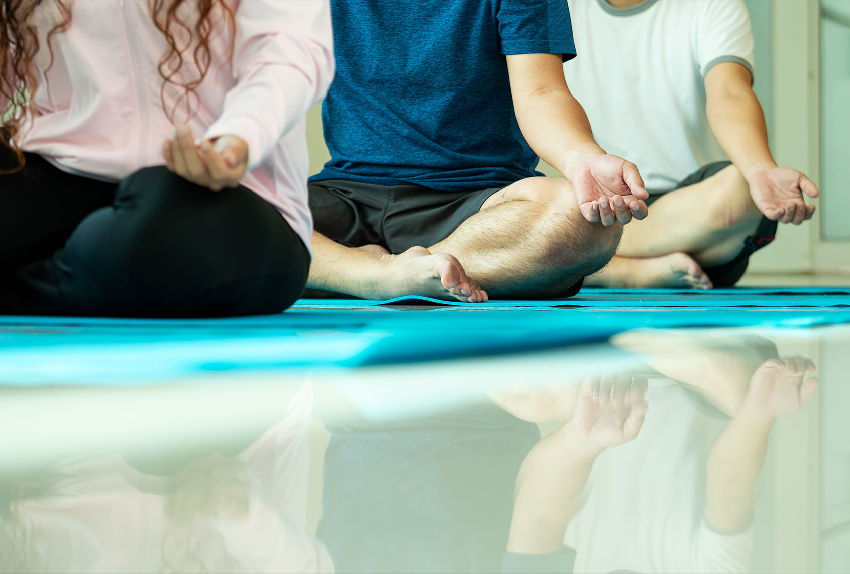 Close-up of three people practicing yoga meditation (Getty Images/Mr Meng)