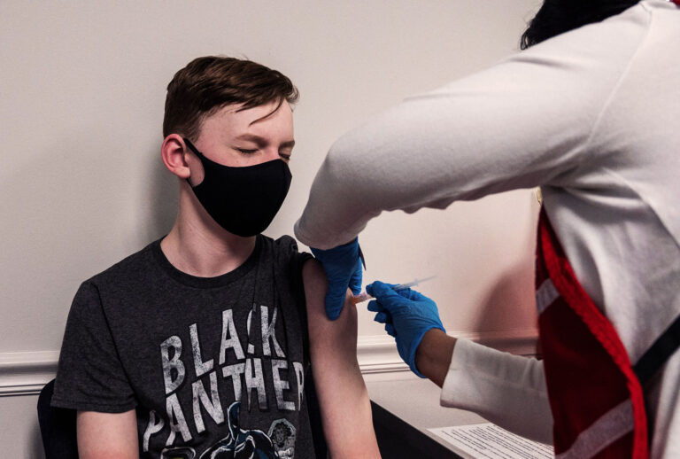 Luke Allan, 13, closes his eyes as he gets a Covid-19 vaccination. The campaign to immunize America's 17 million adolescents aged 12-to-15 kicked off in full force on May 13, a key part of President Joe Biden's strategy to push the country close to herd immunity. (ANDREW CABALLERO-REYNOLDS/AFP via Getty Images)