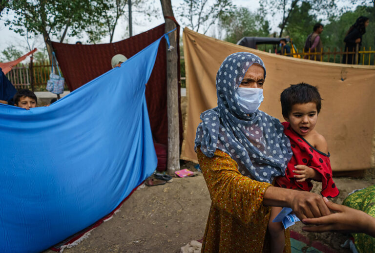 Nooria, 35, decided to leave after the fighting in Kunduz arrived in her home, when a rocket landed in her house and injured her son in his leg and might now require amputation, according to doctors that spoke to her, after she took her entire family and fled to a makeshift camp for displaced Afghans fleeing the fighting between the Taliban and the Afghan Security Forces at Hasa-e-Awal Park, in Kabul, Afghanistan, Saturday, Aug. 14, 2021. (Getty Images/Marcus Yam/Los Angeles Times)