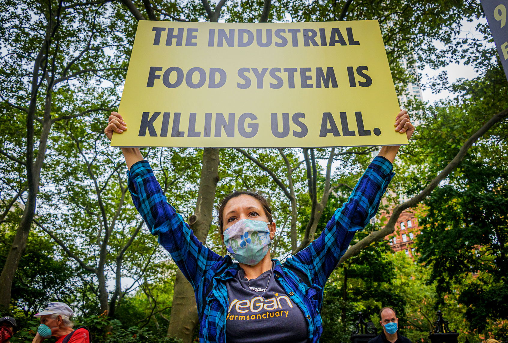 An activists from Extinction Rebellion NYC holding a sign at a climate march. (Erik McGregor/LightRocket via Getty Images)