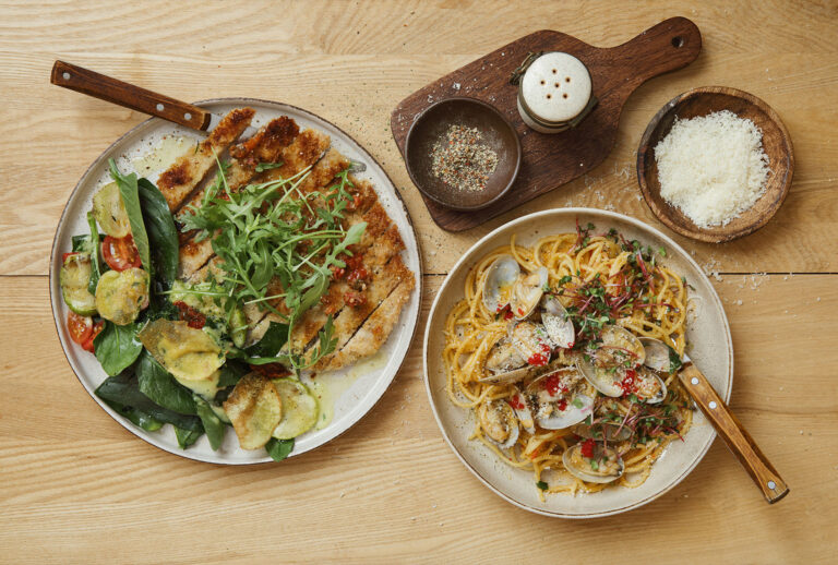 Crispy chicken Milanese. Spinach, grilled zucchini and walnut salad with potato chips. Pasta with vongole and tobiko caviar. (Getty Images)