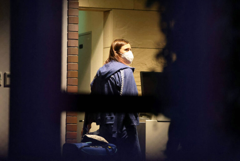 Belarus athlete Krystsina Tsimanouskaya, who claimed her team tried to force her to leave Japan following a row during the Tokyo 2020 Olympic Games, walks with her luggage inside the Polish embassy in Tokyo on August 2, 2021. (YUKI IWAMURA/AFP via Getty Images)