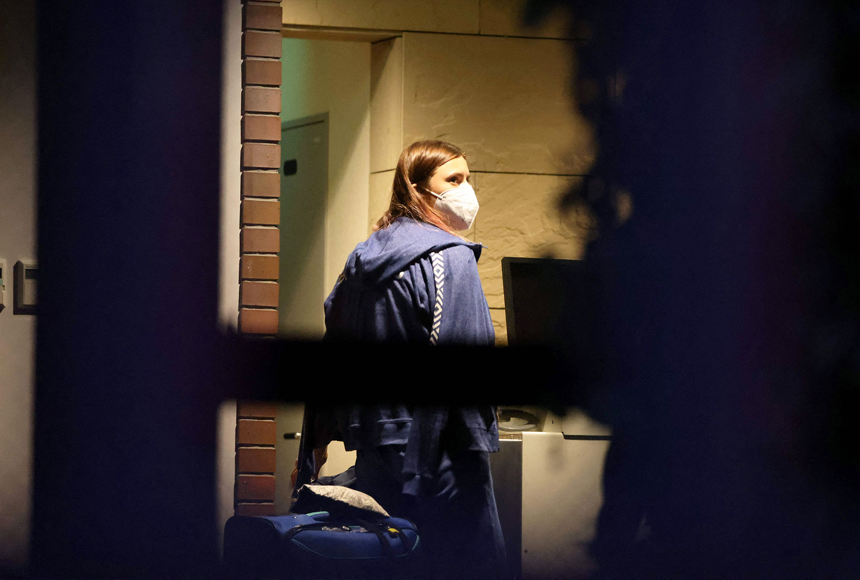 Belarus athlete Krystsina Tsimanouskaya, who claimed her team tried to force her to leave Japan following a row during the Tokyo 2020 Olympic Games, walks with her luggage inside the Polish embassy in Tokyo on August 2, 2021. (YUKI IWAMURA/AFP via Getty Images)