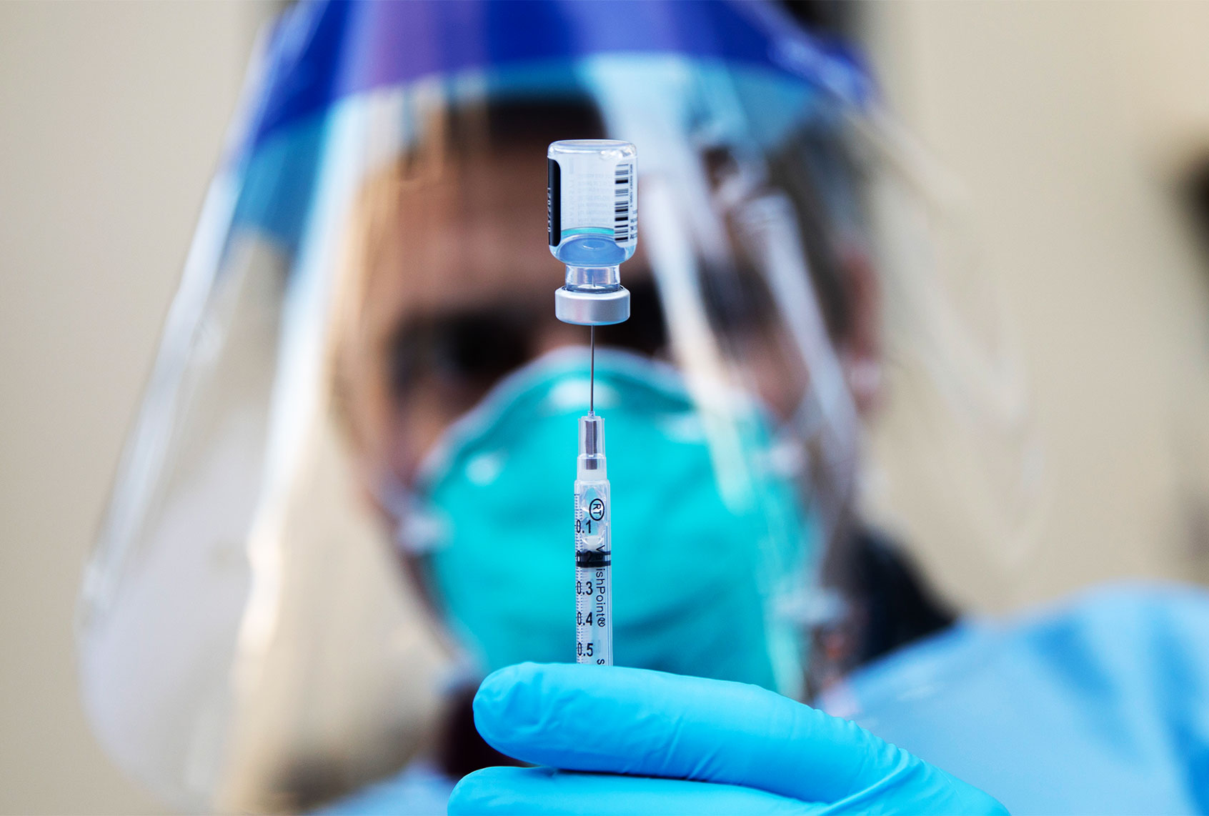 Marin County Fire medic Kevin Stone prepares a dose of the Pfizer COVID-19 vaccine to be administered to staff at The Tamalpais Marin assisted living facility in Greenbrae, California. (Jessica Christian/The San Francisco Chronicle via Getty Images)