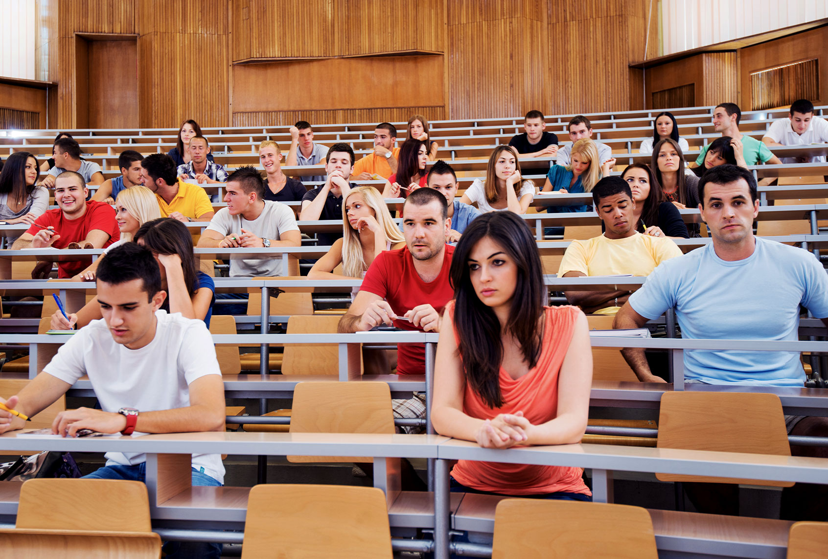 Large group of students at university lecture hall (Getty Images/skynesher)