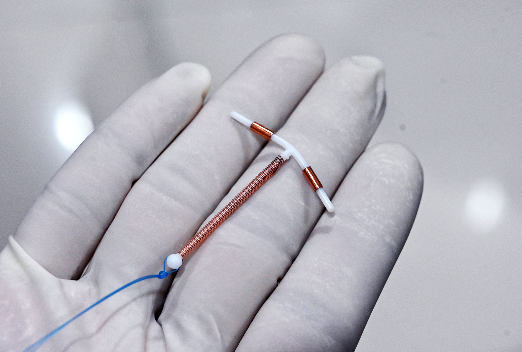 A doctor holding an IUD birth control device (ADEK BERRY/AFP via Getty Images)