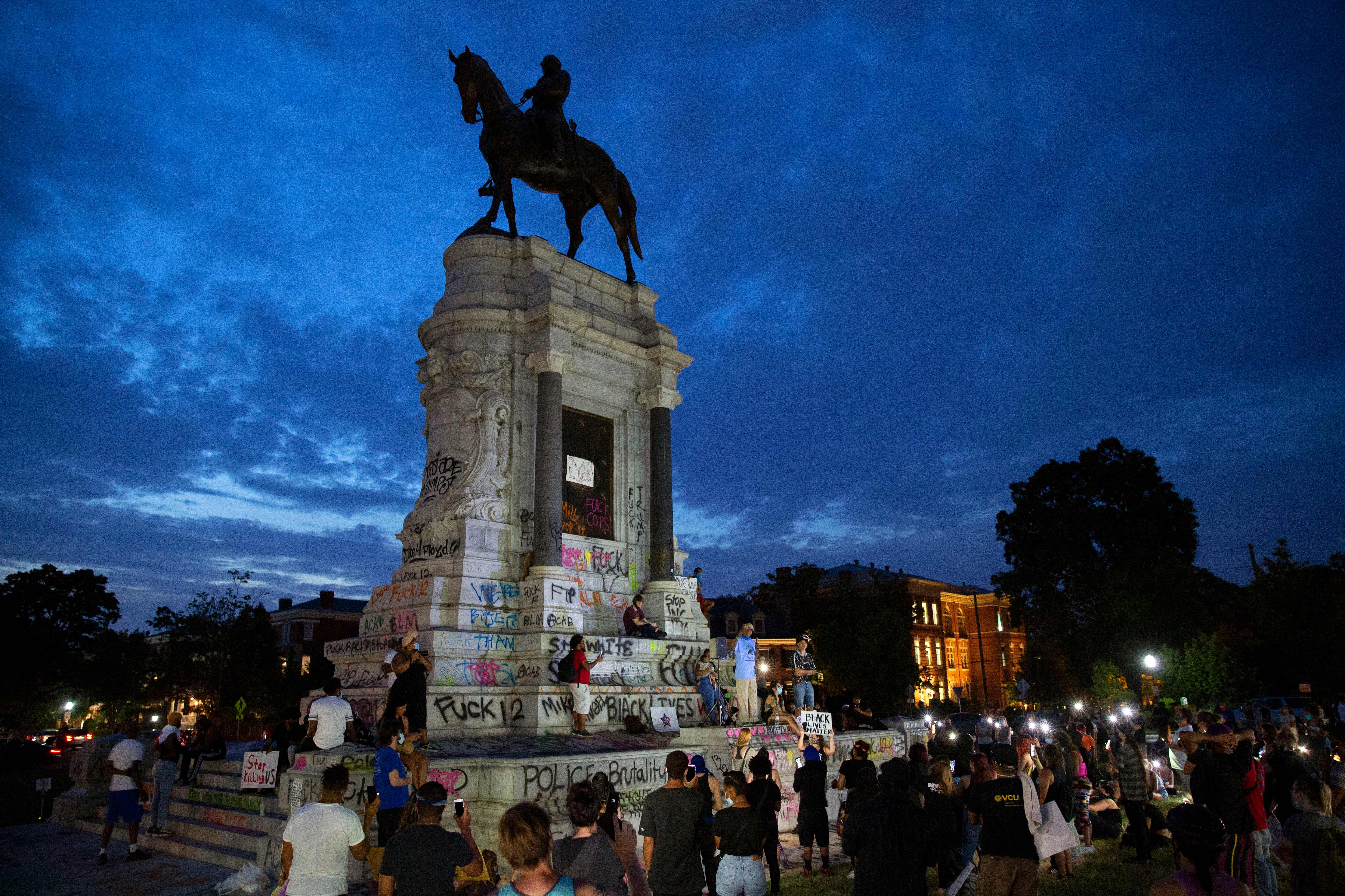 People gather around the Robert E. Lee statue on Monument Avenue in Richmond, Virginia, on June 4, 2020, amid continued protests over the death of George Floyd in police custody. (Ryan M. Kelly/AFP via Getty Images)