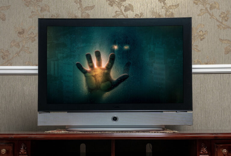 TV screen with spooky figure in the monitor (Getty Images/Andyborodaty)