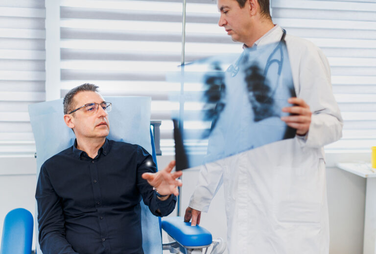 Patient speaking with doctor about scans (Getty Images/zoranm)
