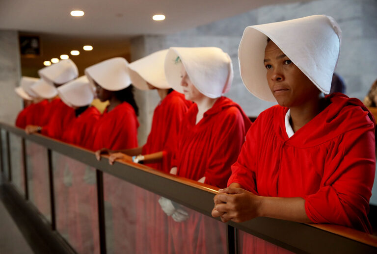 Protesters dressed in The Handmaid's Tale costume, protest outside the hearing room where Supreme Court nominee Judge Brett Kavanaugh will testify before the Senate Judiciary Committee during his Supreme Court confirmation hearing in the Hart Senate Office Building on Capitol Hill September 4, 2018 in Washington, DC. (Win McNamee/Getty Images)