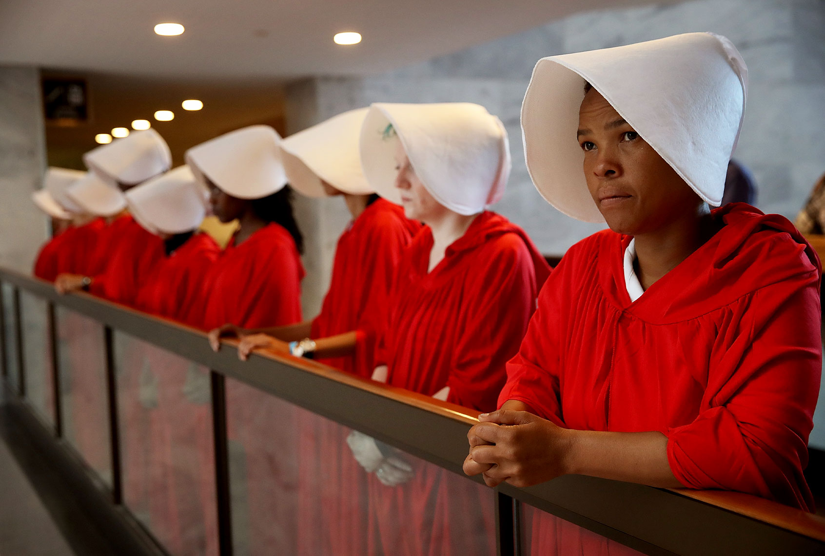Protesters dressed in The Handmaid's Tale costume, protest outside the hearing room where Supreme Court nominee Judge Brett Kavanaugh will testify before the Senate Judiciary Committee during his Supreme Court confirmation hearing in the Hart Senate Office Building on Capitol Hill September 4, 2018 in Washington, DC. (Win McNamee/Getty Images)