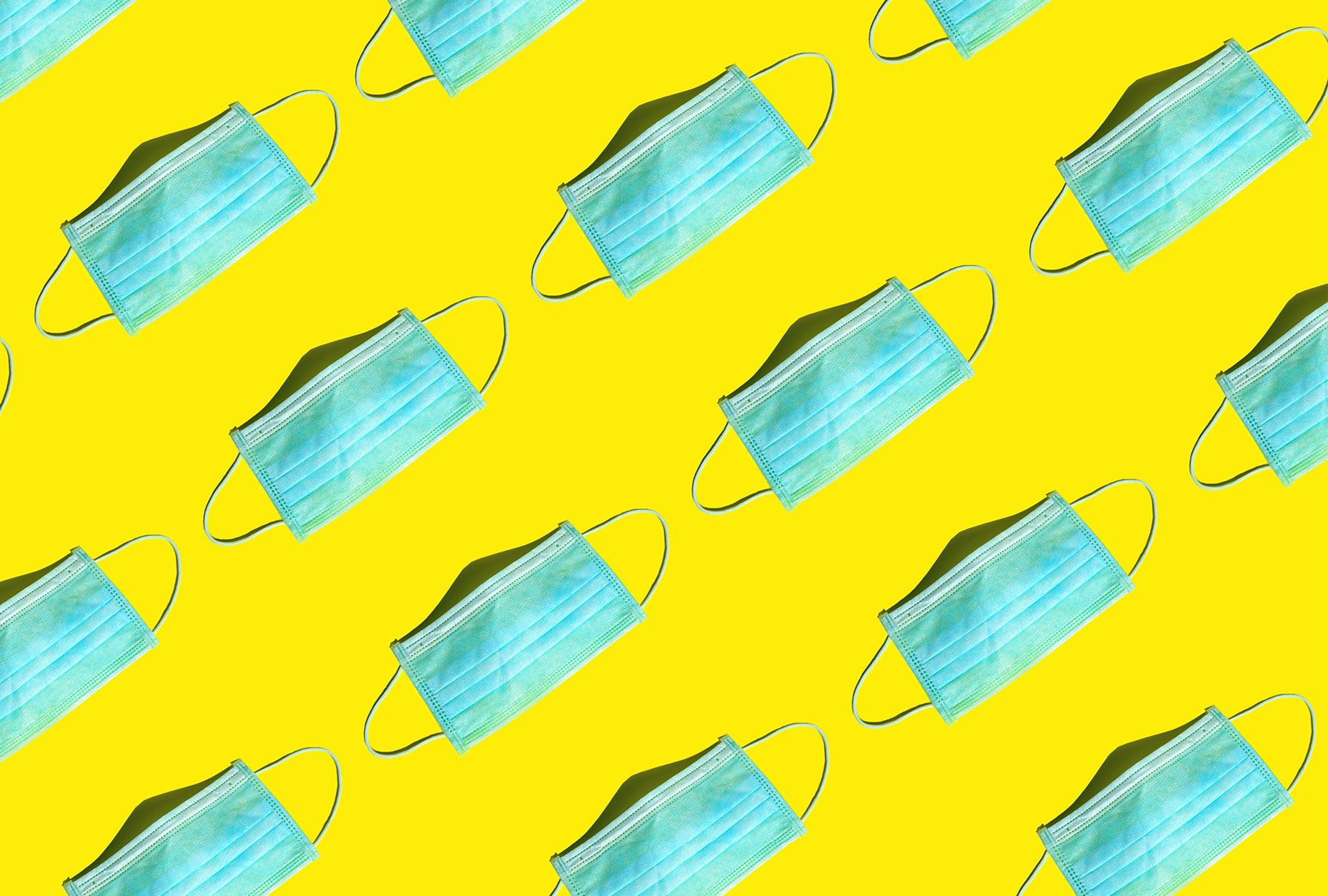 Medical surgical face masks on a bright yellow background (Getty Images/Yulia Shaihudinova)