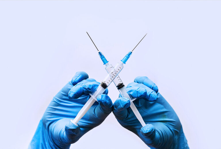 Two vaccine syringes (Getty Images/golibtolibov)