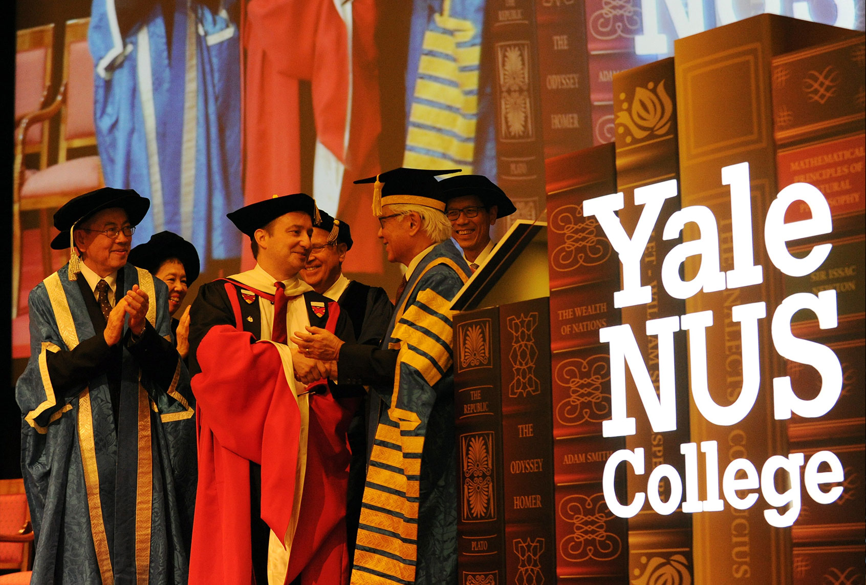 Singapore President Tony Tan Keng Yam (R) shakes hands with Professor Pericles Lewis (C), president of Yale-NUS college after officiating the inauguration ceremony to mark the start of the Yale-NUS College while other officials look on in SIngapore on August 27, 2013. (ROSLAN RAHMAN/AFP via Getty Images)