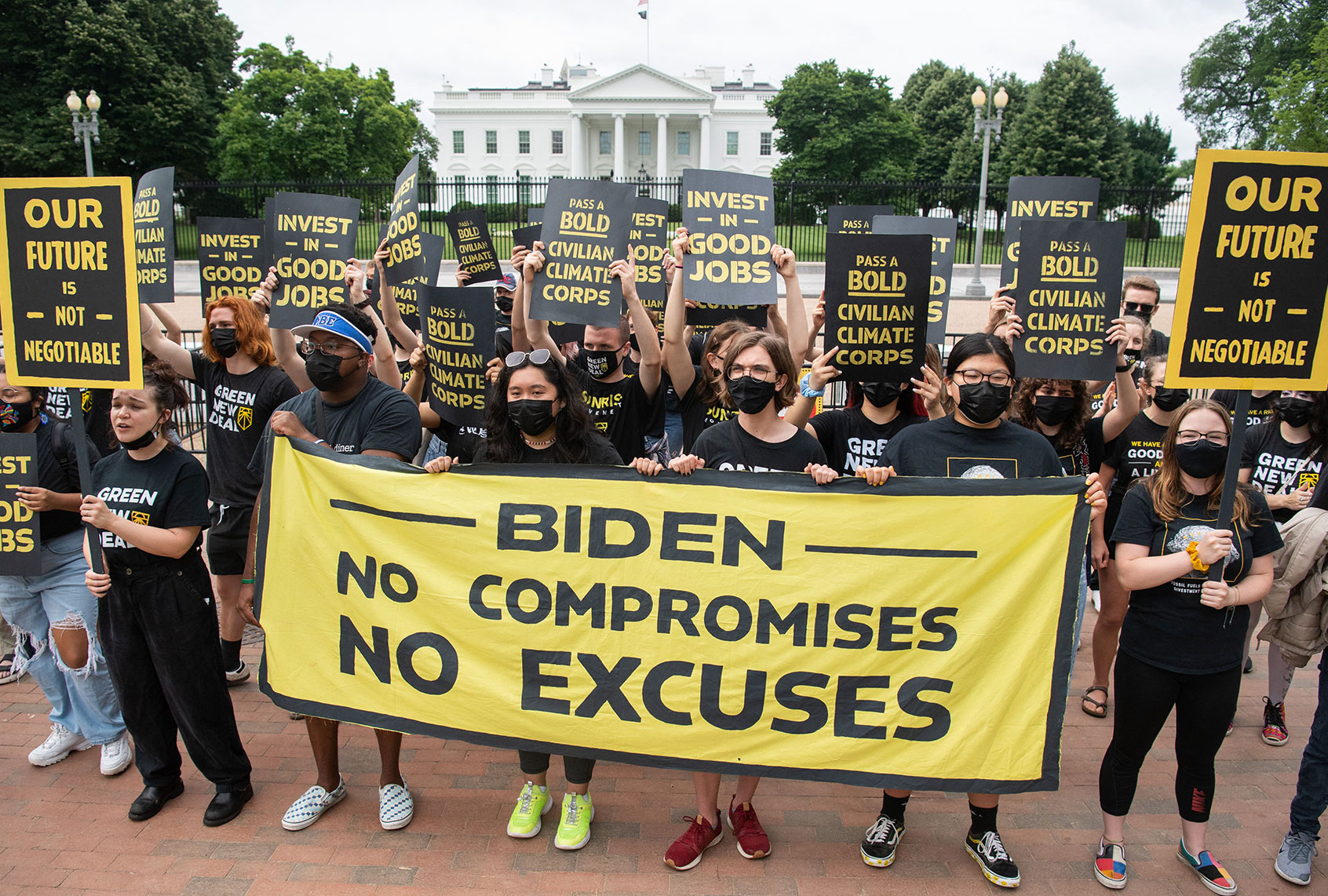Protesters with the Sunrise Movement protest in front of the White House against what they say is slow action on infrastructure legislation, job creation and addressing climate change, as well as against attempts to work with Senate Republicans in Washington, DC, June 4, 2021. (SAUL LOEB/AFP via Getty Images)