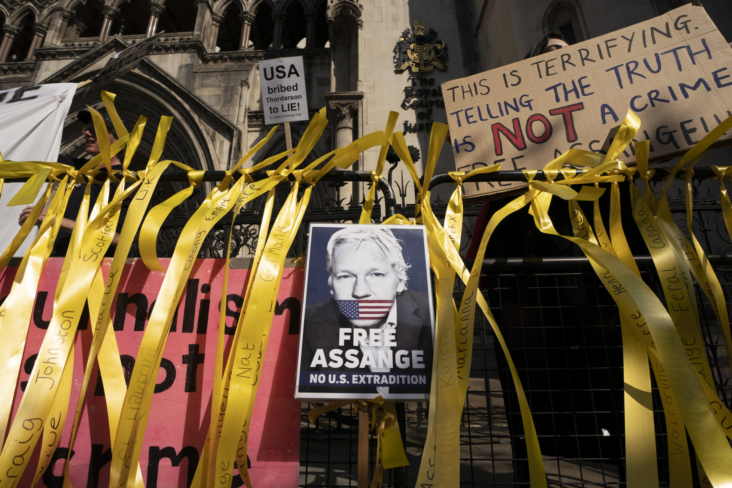Supporters gather outside as the High Court hears a U.S. appeal in the extradition of WikiLeaks founder Julian Assange, at Royal Courts of Justice, Chancery Lane, London, Aug. 11, 2021. (Ming Yeung/Getty Images)