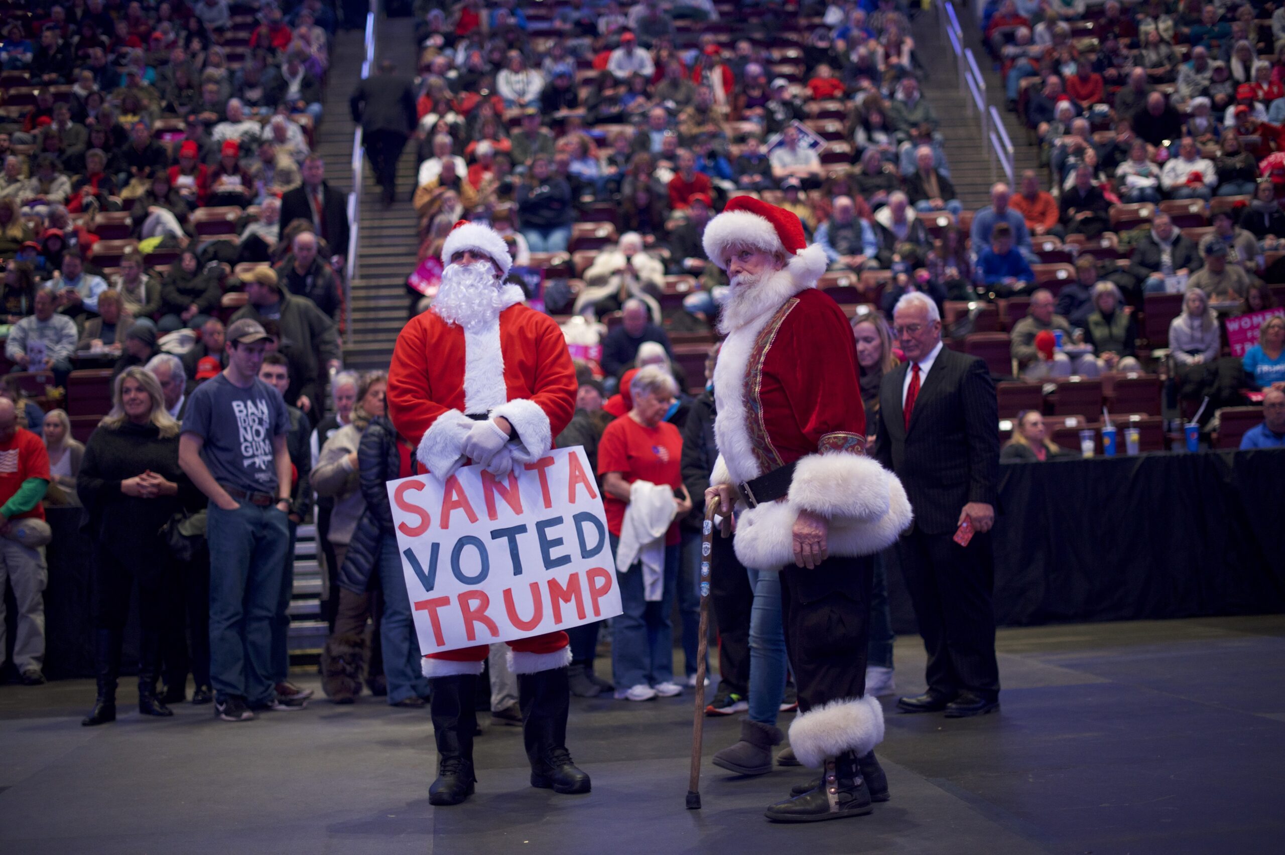 A Trump supporter in a Santa costume holds a sign that reads "Santa voted Trump." (Mark Makela/Getty Images)