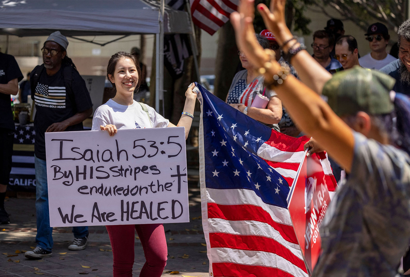 A woman holds a sign quoting the Bible as anti-vaccination protesters pray and gather near Los Angeles City Hall on August 14, 2021 (DAVID MCNEW/AFP via Getty Images)