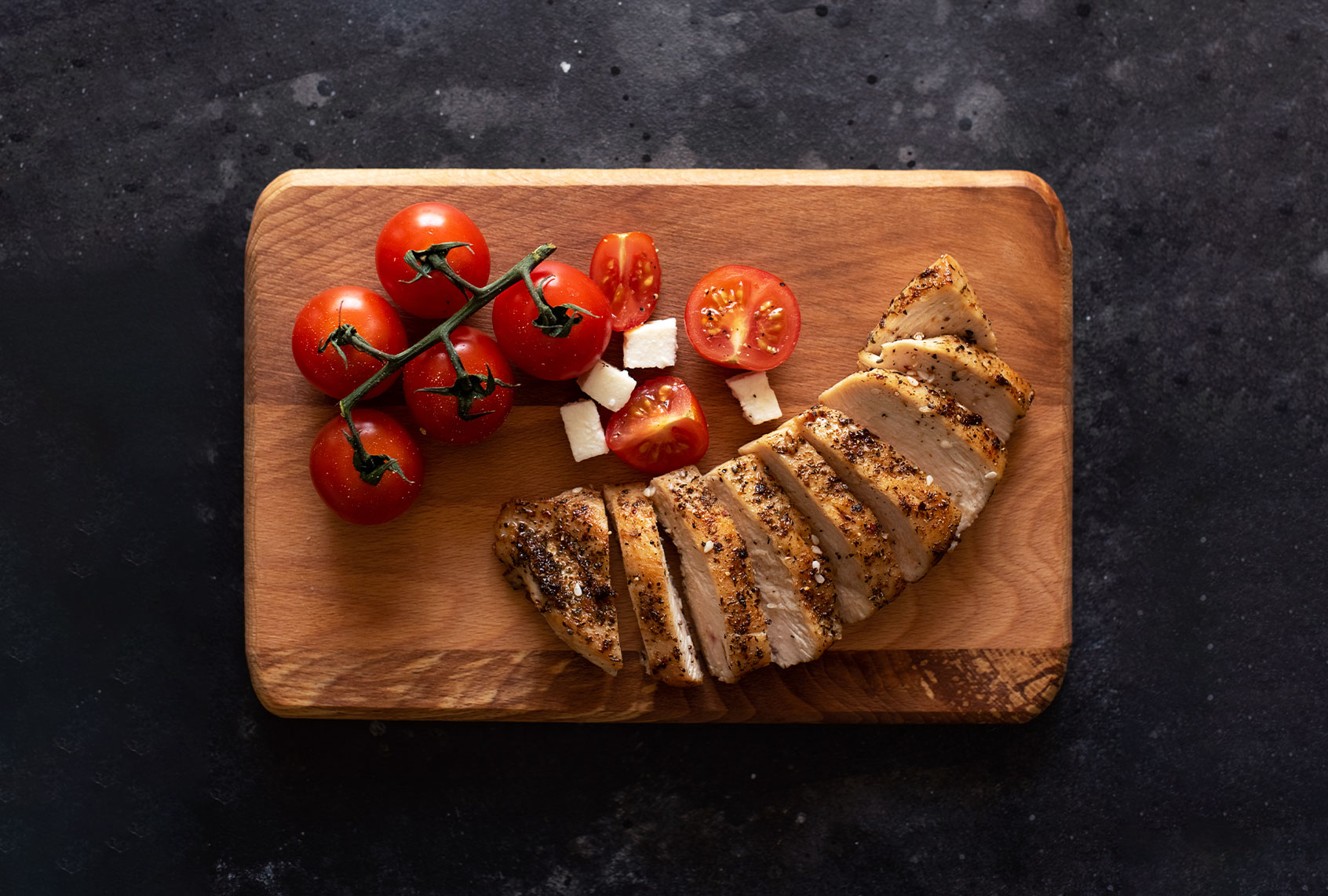Chicken and tomatoes on a board (Getty Images/Kseniya Ovchinnikova)