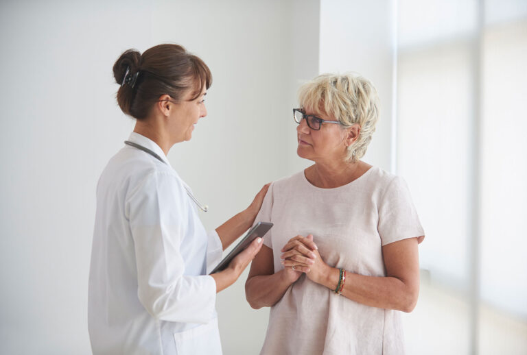 Doctor delivering news to patient (Getty Images/LWA)