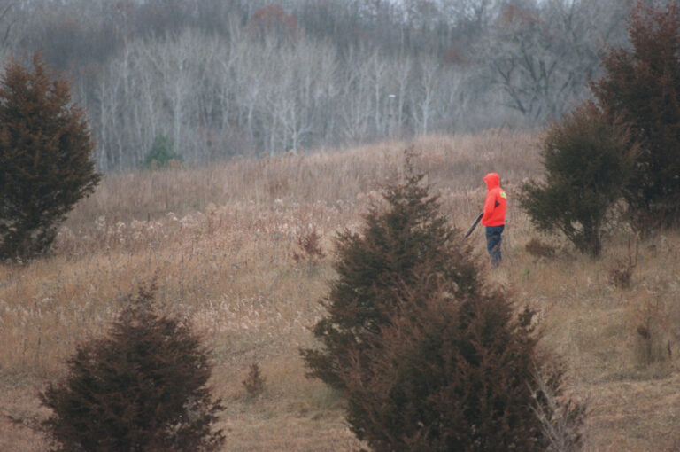 A hunter stands motionless as he waits for a deer to come into shooting range. (JOHN CROFT/Star Tribune via Getty Images)