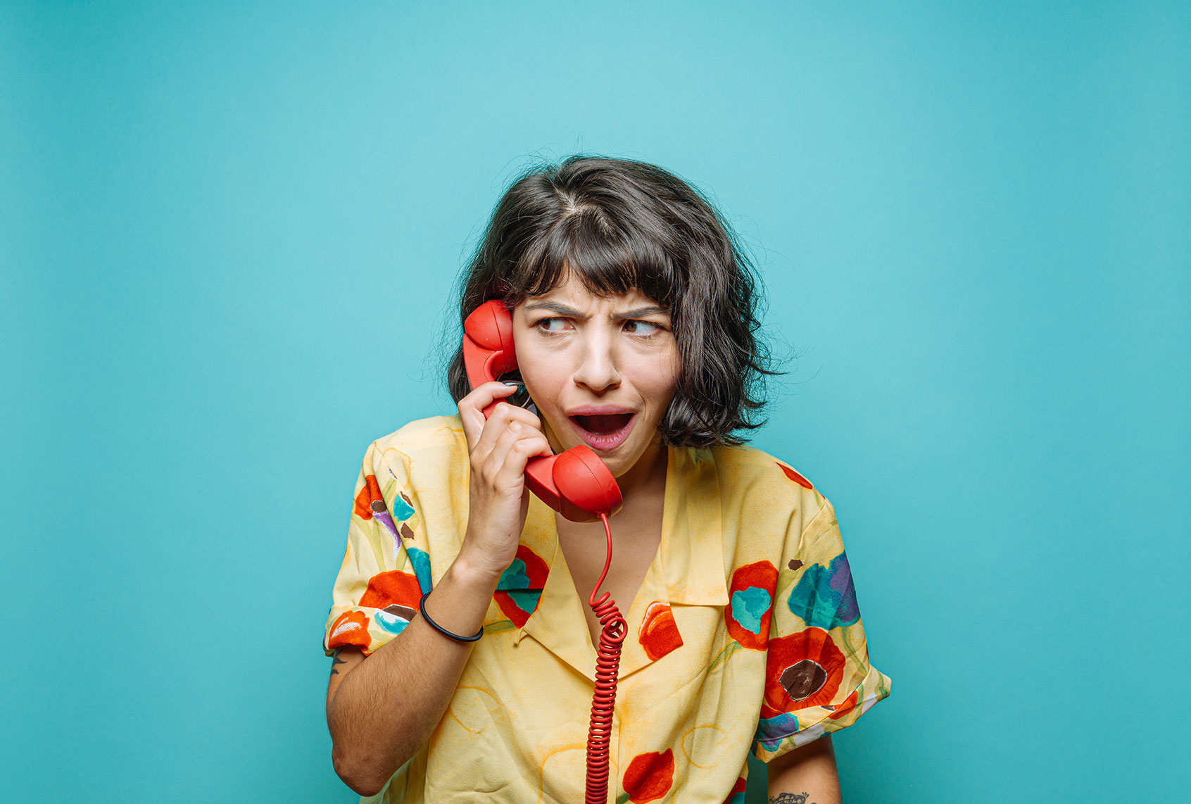 Young woman on the phone making a face (Getty Images/Ian Ross Pettigrew)