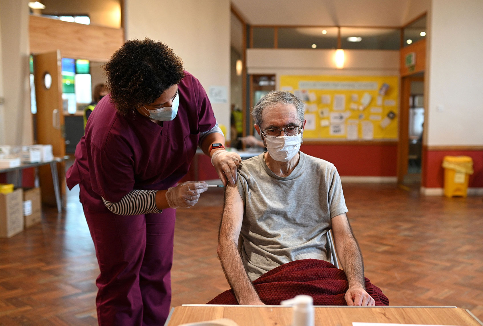 A man receives a dose of the Pfizer Covid-19 vaccine in a vaccination clinic set up at St Columba's Church in Sheffield on December 15, 2021 as the UK steps up the country's booster drive to fight a "tidal wave" of Omicron. - The country's medical advisers have raised the Covid Alert Level due to a "rapid increase" in infection from the variant. (OLI SCARFF/AFP via Getty Images)