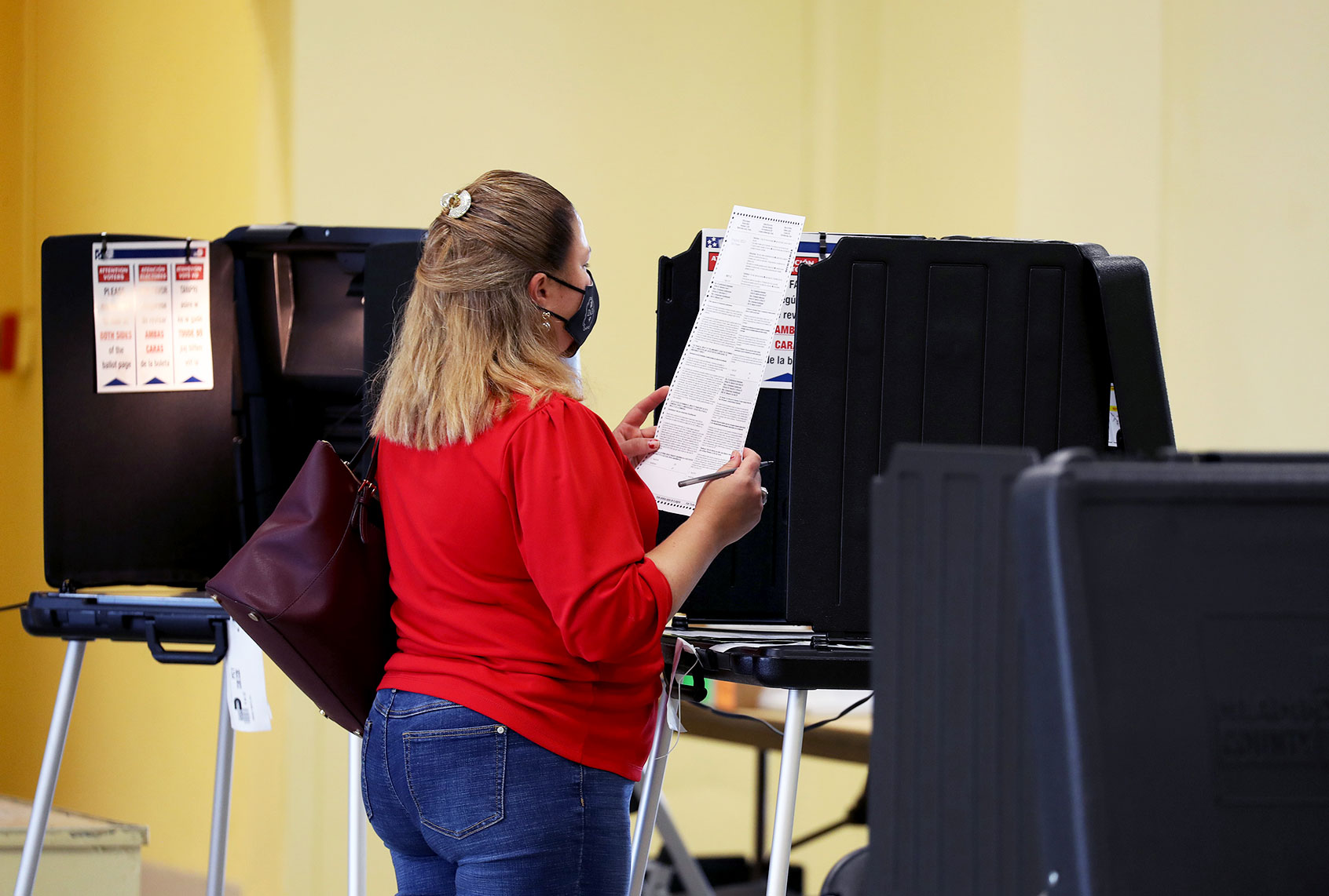 Susana Vasquez reads her ballot while voting at the Legion Park polling place on November 03, 2020 in Miami, Florida. After a record-breaking early voting turnout, Americans head to the polls on the last day to cast their vote for incumbent U.S. President Donald Trump or Democratic nominee Joe Biden in the 2020 presidential election. (Joe Raedle/Getty Images)
