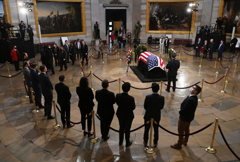 People pay their respects to former Senator Bob Dole (R-KS) in the US Capitol rotunda on December 9, 2021 in Washington, DC. (MATT MCCLAIN/POOL/AFP via Getty Images)