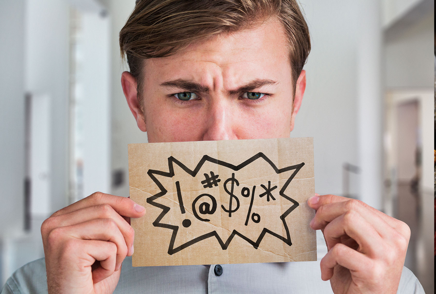 Man holding a swear word sign in front of his mouth (Getty Images/Dimitri Otis)